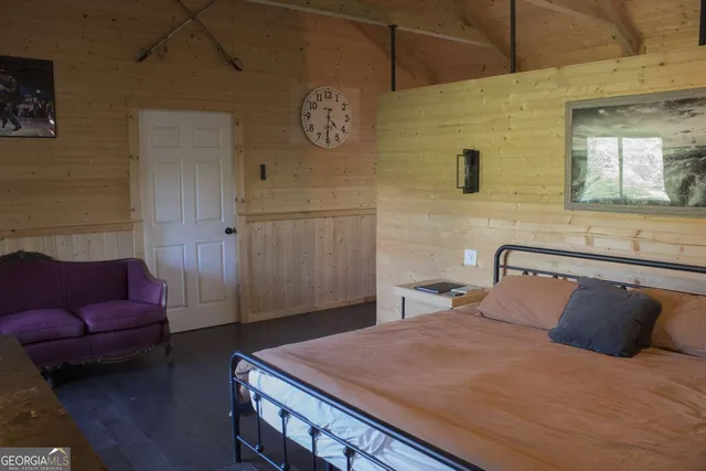 a bedroom with a bed and a couch