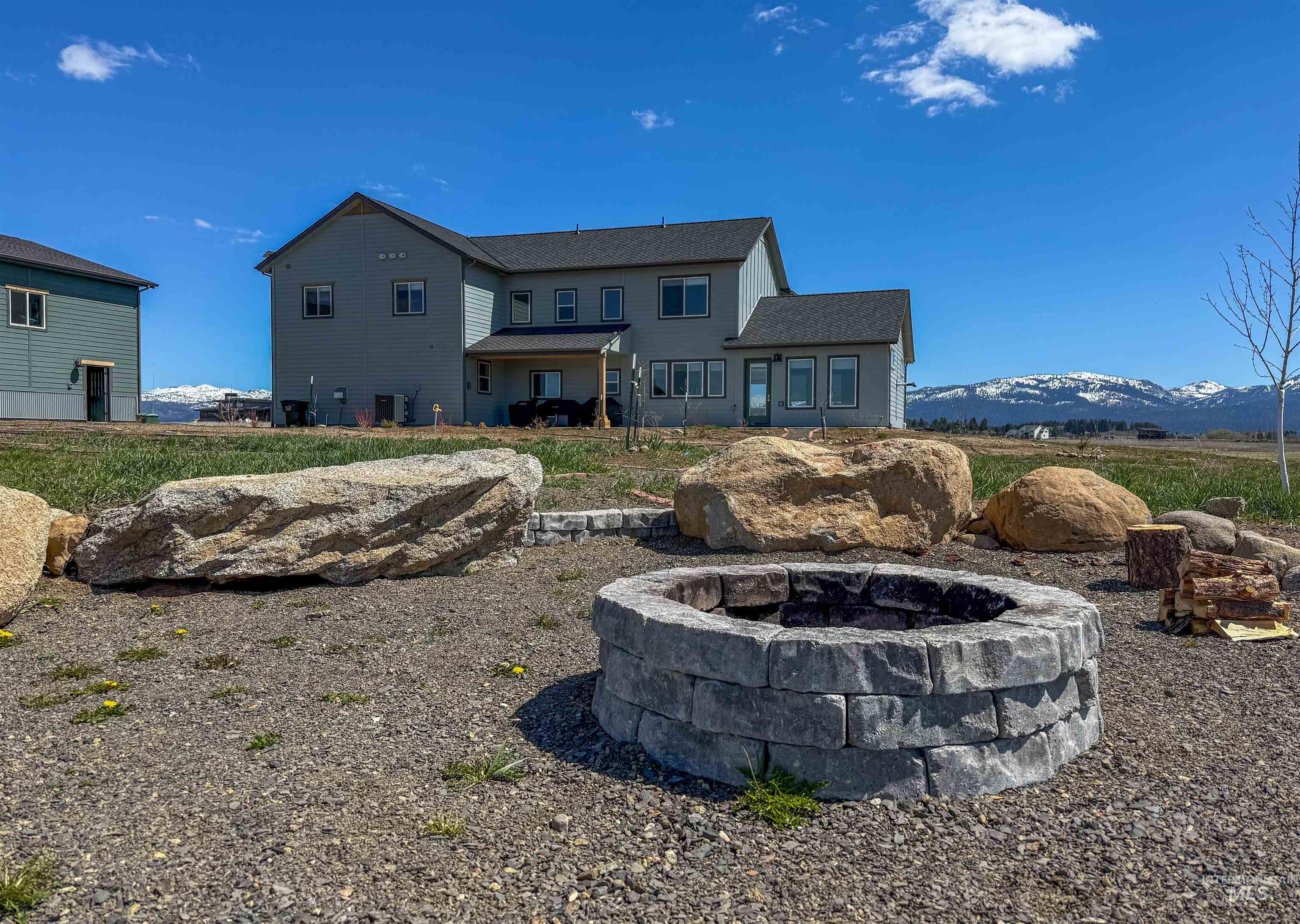 44 Big Moose Road McCall, ID 83638 - Photo 3 of 50 Outdoor fire pit constructed with stone blocks, complemented by large natural boulders