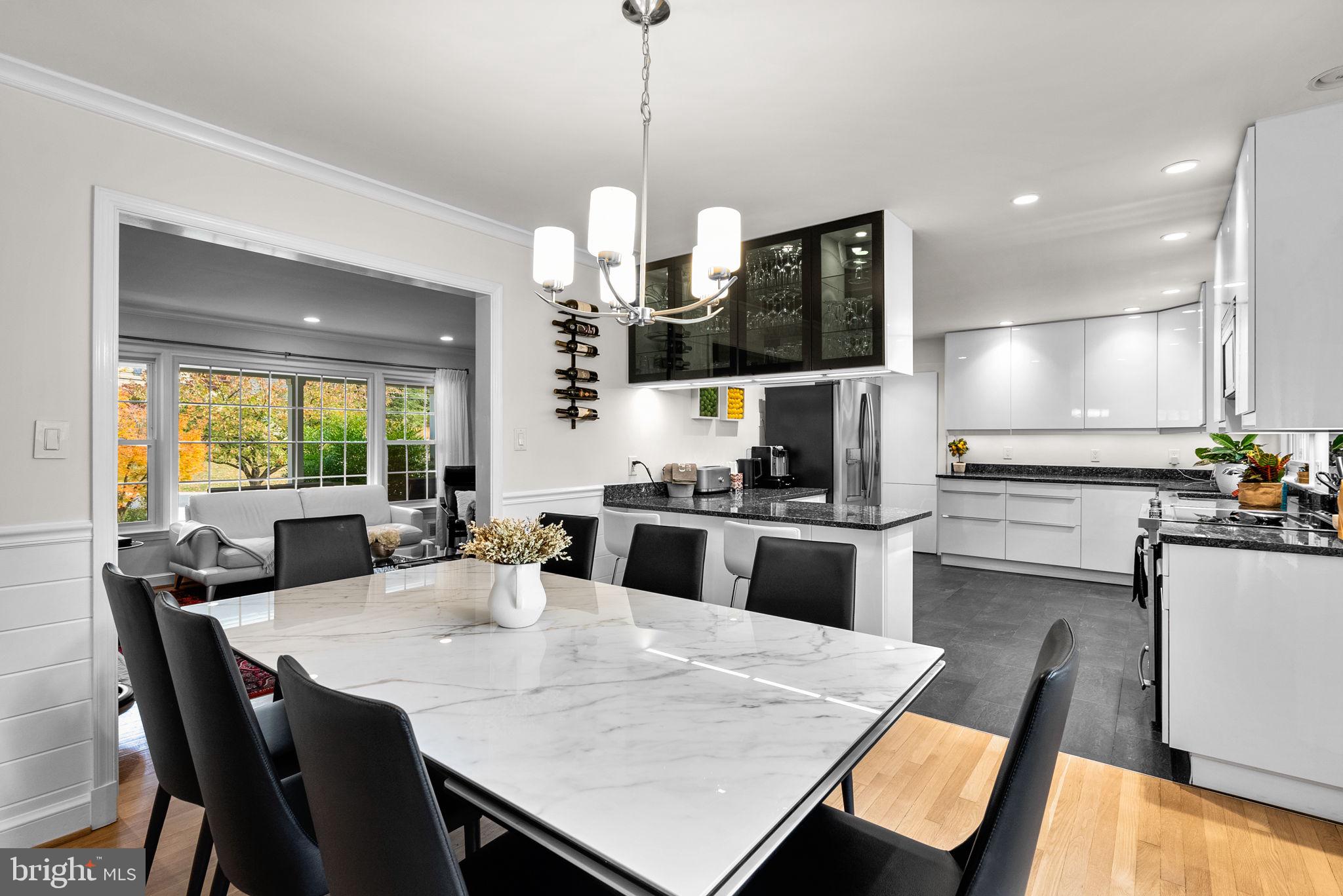 4111 Clagett Road Hyattsville, MD 20782 - Photo 11 of 61 a kitchen with a dining table chairs and refrigerator