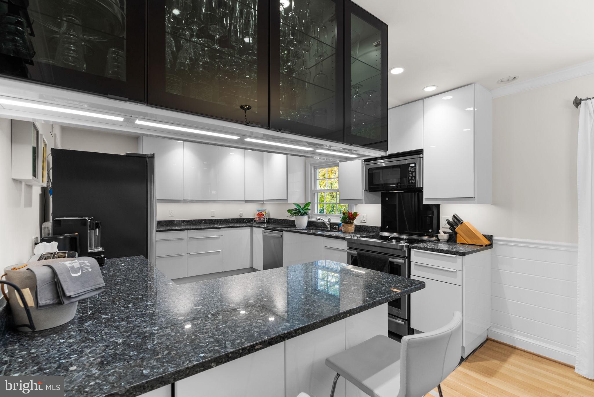 4111 Clagett Road Hyattsville, MD 20782 - Photo 14 of 61 a kitchen with stainless steel appliances a sink a stove and a wooden floor