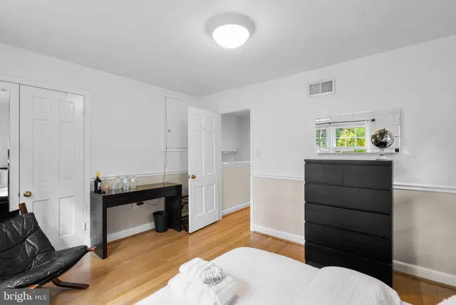 a bedroom with a bed and cabinets