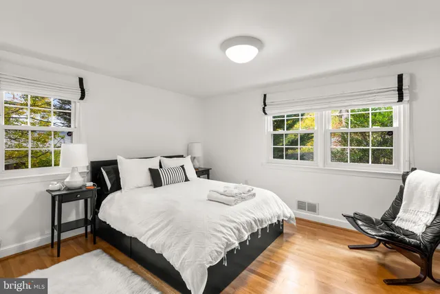 a bedroom with a bed and a chair