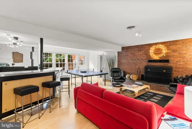 a living room with fireplace furniture and a large window
