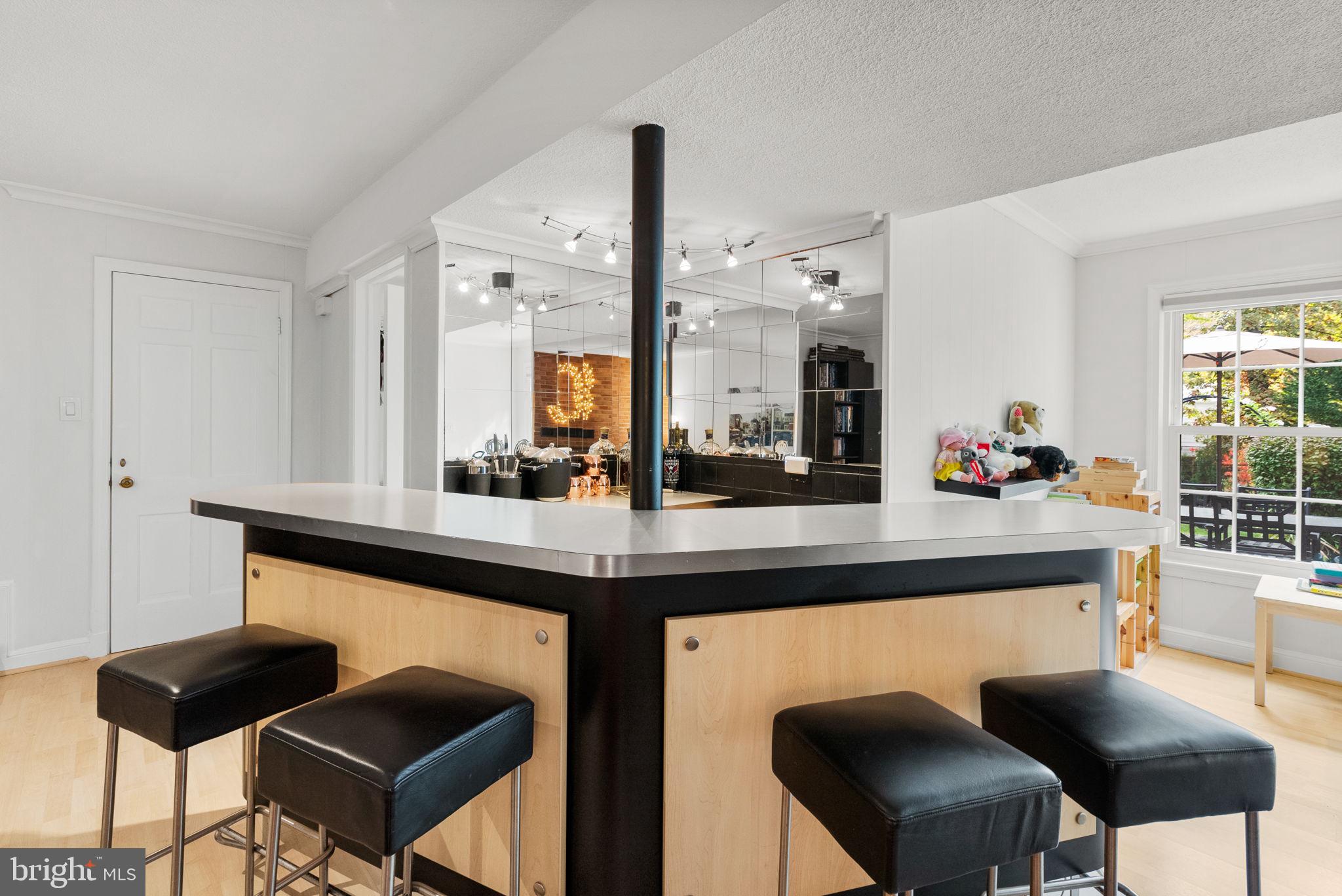 4111 Clagett Road Hyattsville, MD 20782 - Photo 34 of 61 a kitchen with a dining table chairs sink and granite counter top