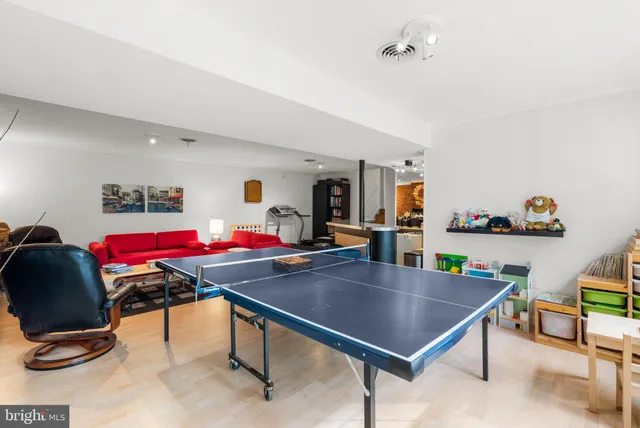 a living room with furniture and a piano