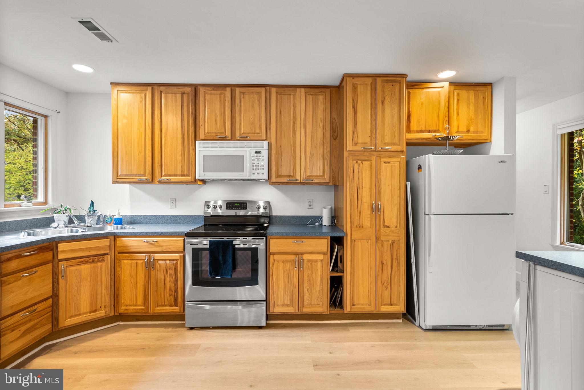 4111 Clagett Road Hyattsville, MD 20782 - Photo 43 of 61 a kitchen with stainless steel appliances granite countertop a refrigerator a stove a sink and a microwave