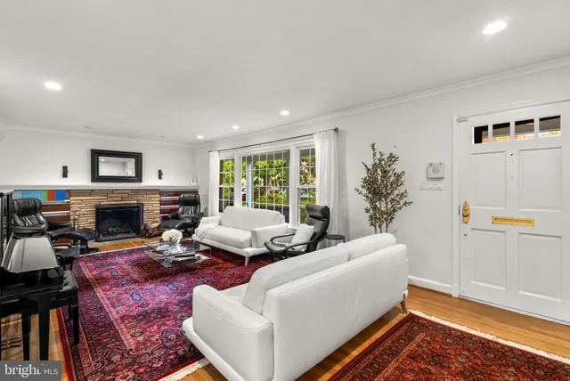a living room with furniture fireplace and a window