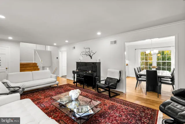 a living room with furniture dining table and a flat screen tv