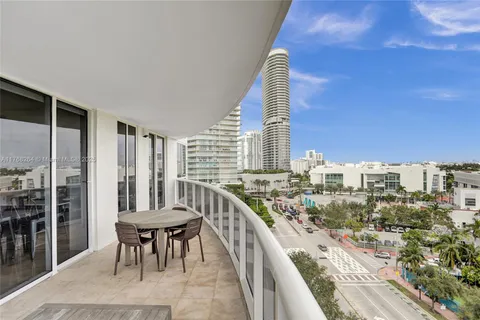 a view of balcony with chairs and city view
