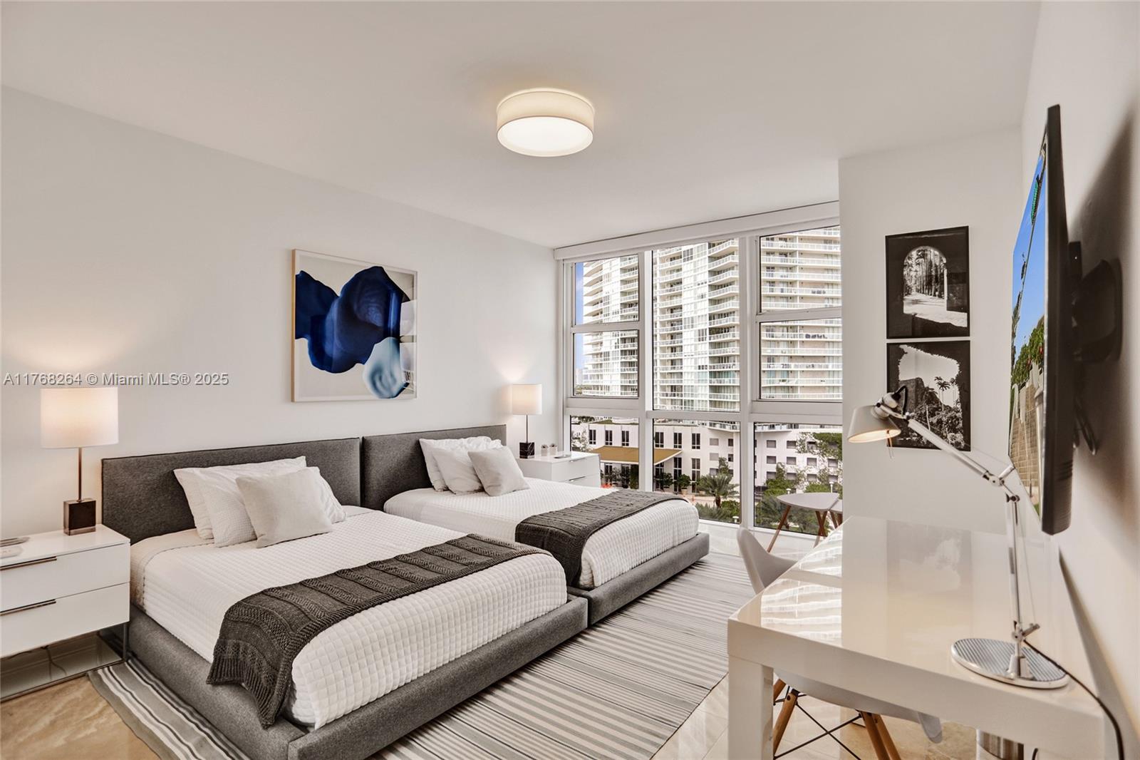 400 Alton Road, Unit 911 Miami Beach, FL 33139 - Photo 14 of 24 a bedroom with furniture and a large window