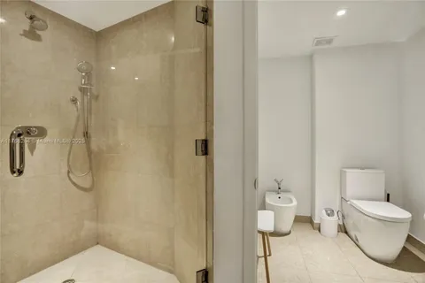 a bathroom with a toilet and a shower