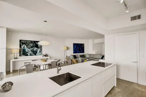 a living room with furniture a flat screen tv and a window