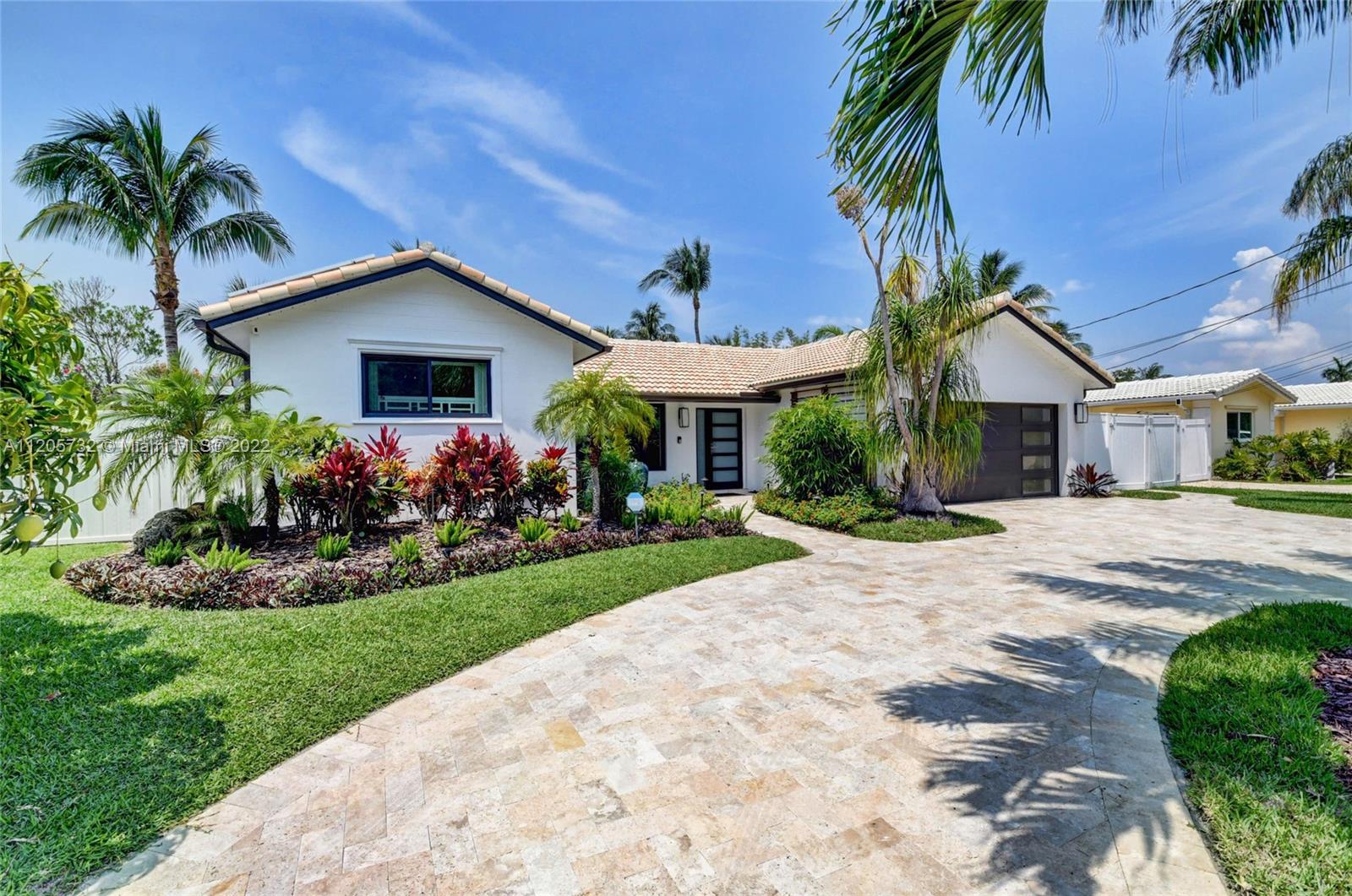 1291 Southwest 4th Court Boca Raton, FL 33432 - Photo 1 of 54 a front view of house with yard and green space