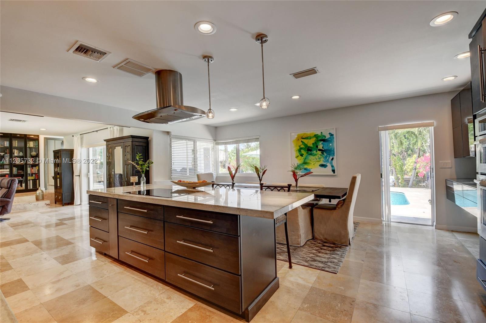 1291 Southwest 4th Court Boca Raton, FL 33432 - Photo 16 of 54 an open kitchen with a table and chairs in it
