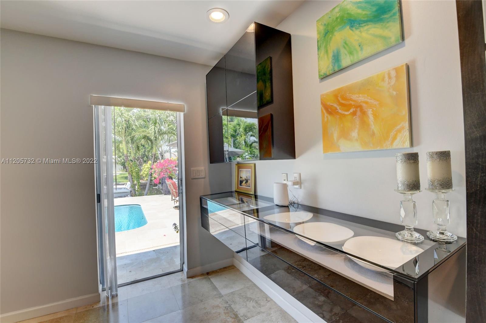 1291 Southwest 4th Court Boca Raton, FL 33432 - Photo 17 of 54 a bathroom with a granite countertop sink and a mirror