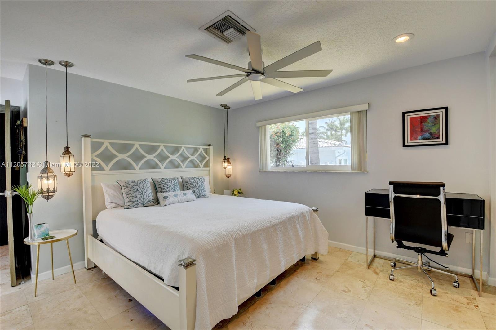 1291 Southwest 4th Court Boca Raton, FL 33432 - Photo 18 of 54 a bedroom with a bed and a desk