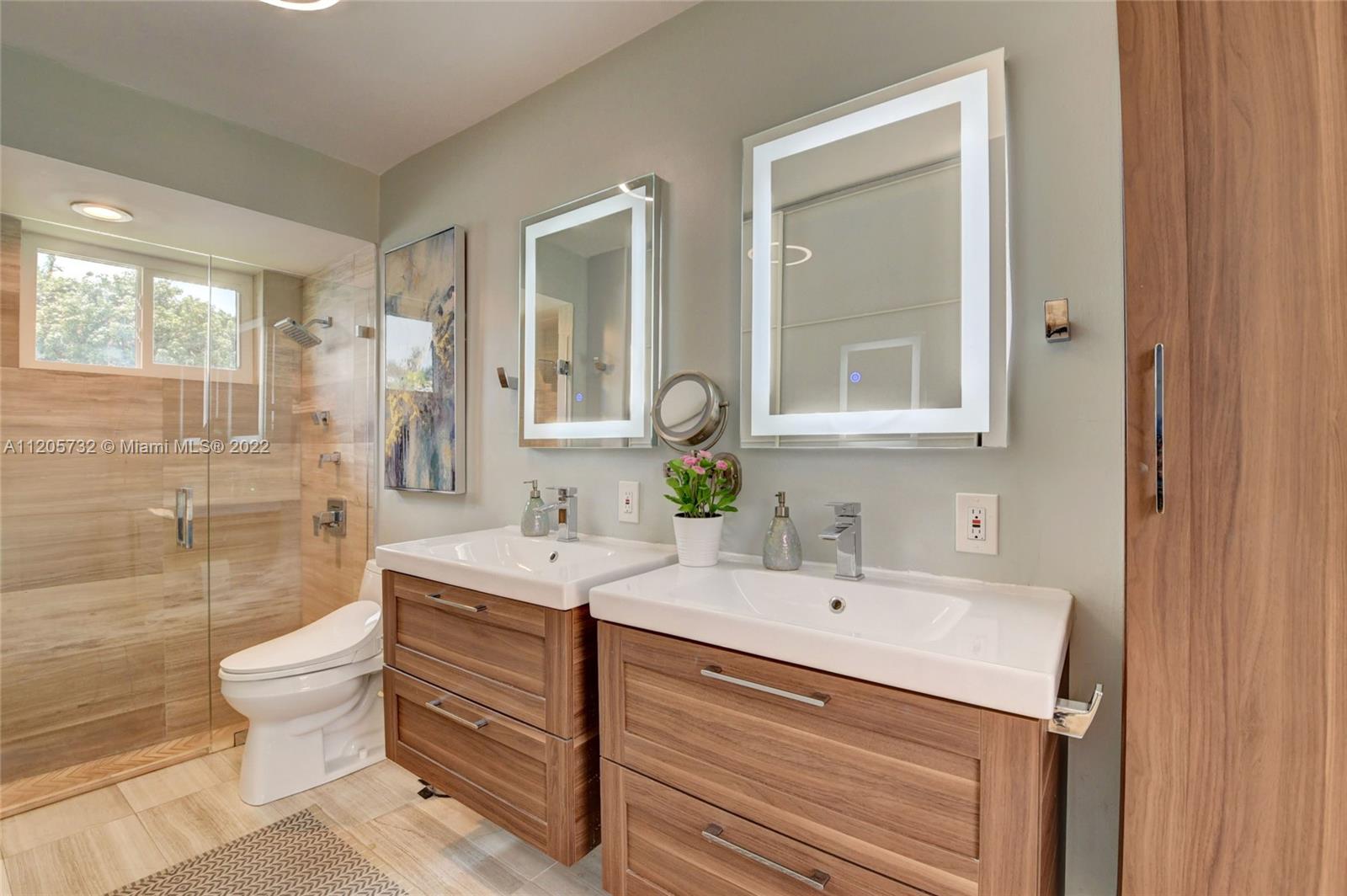 1291 Southwest 4th Court Boca Raton, FL 33432 - Photo 20 of 54 a bathroom with a sink and a mirror