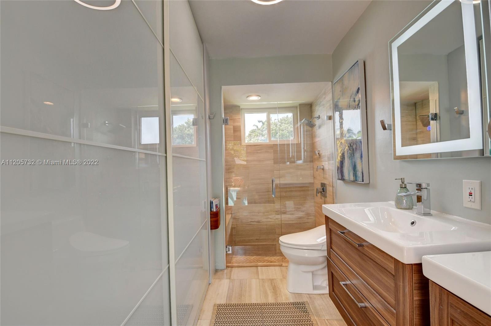 1291 Southwest 4th Court Boca Raton, FL 33432 - Photo 21 of 54 a bathroom with a sink a toilet and shower