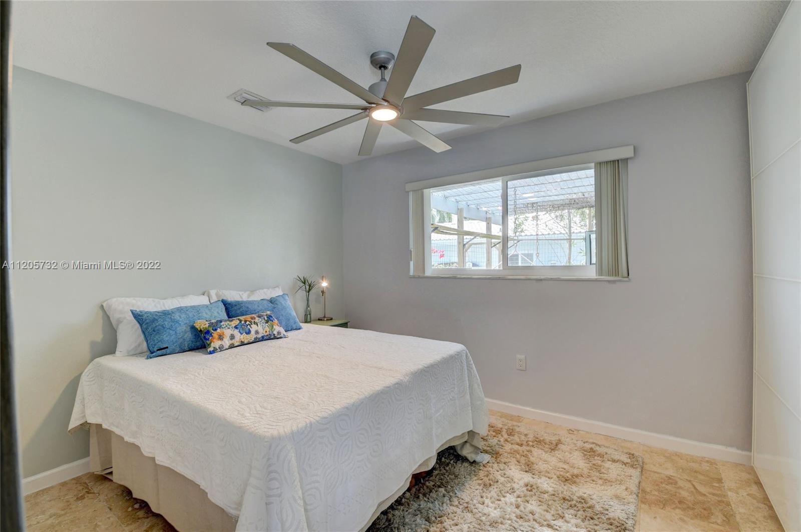 1291 Southwest 4th Court Boca Raton, FL 33432 - Photo 23 of 54 a bedroom with a large bed and a window