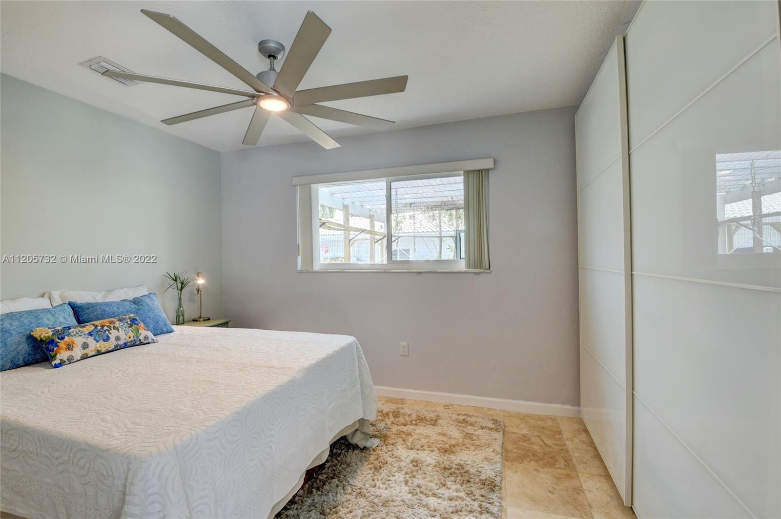 1291 Southwest 4th Court Boca Raton, FL 33432 - Photo 24 of 54 a bedroom with a large bed and a window