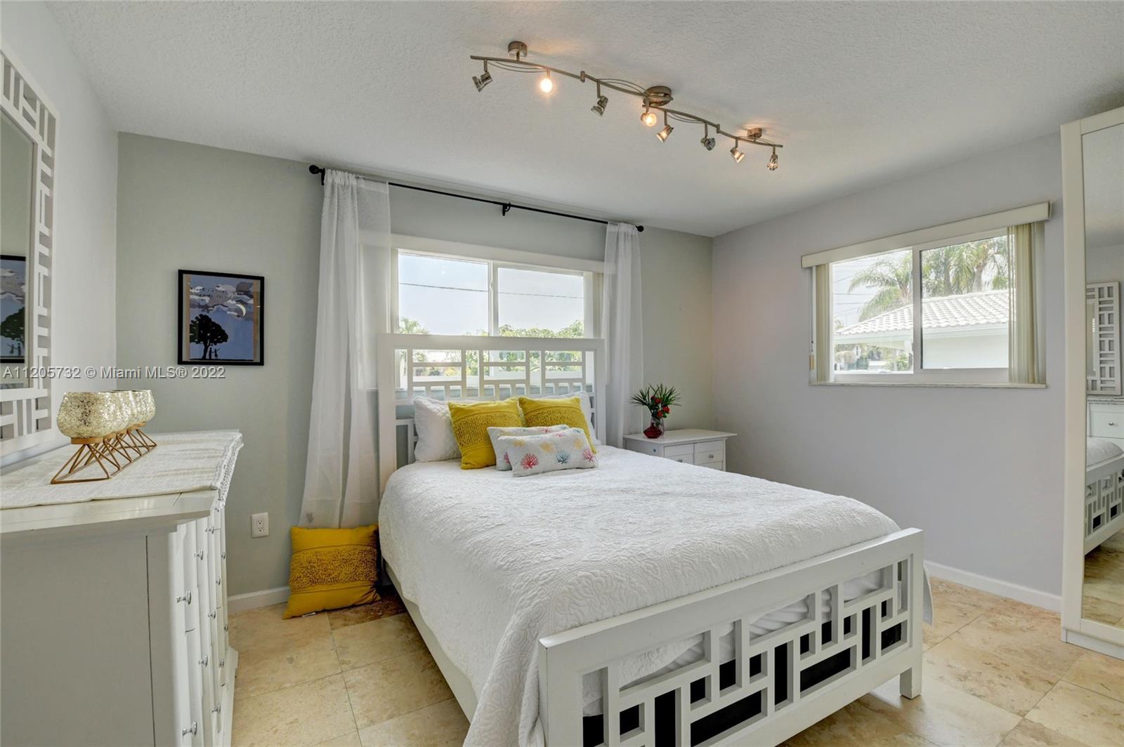 1291 Southwest 4th Court Boca Raton, FL 33432 - Photo 26 of 54 a bedroom with a bed next to a window