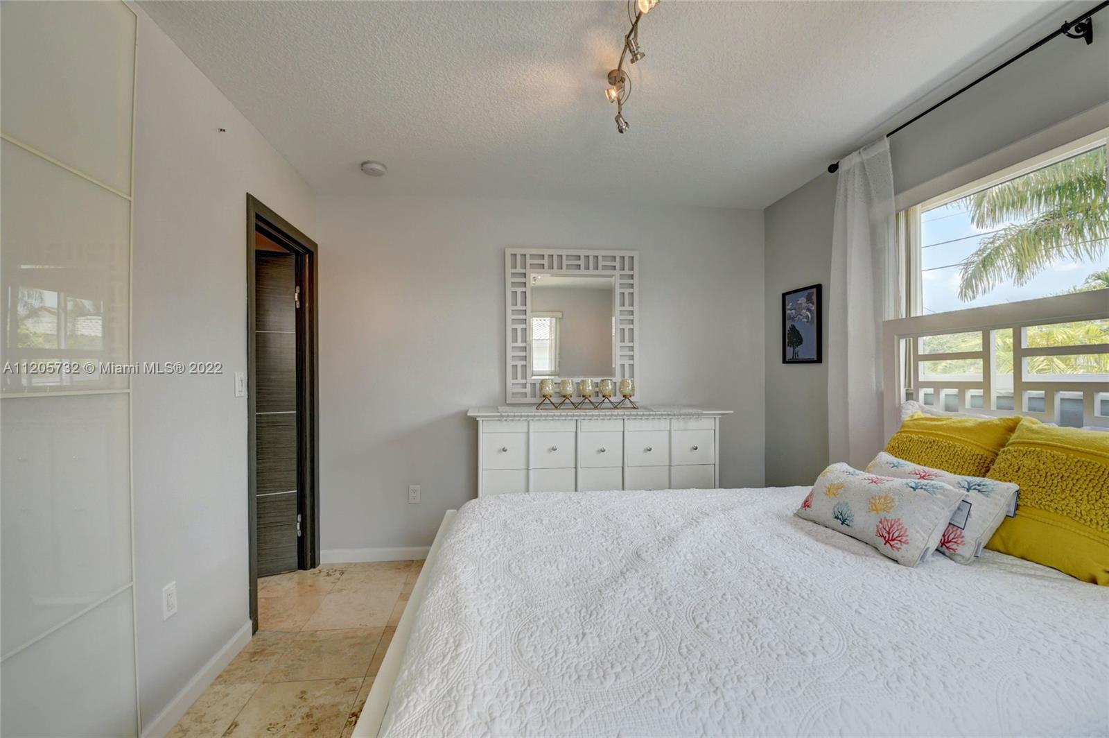 1291 Southwest 4th Court Boca Raton, FL 33432 - Photo 27 of 54 a bedroom with a bed and wooden floor