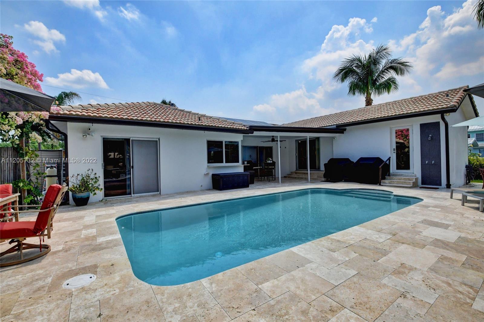 1291 Southwest 4th Court Boca Raton, FL 33432 - Photo 32 of 54 a view of a house with backyard and porch