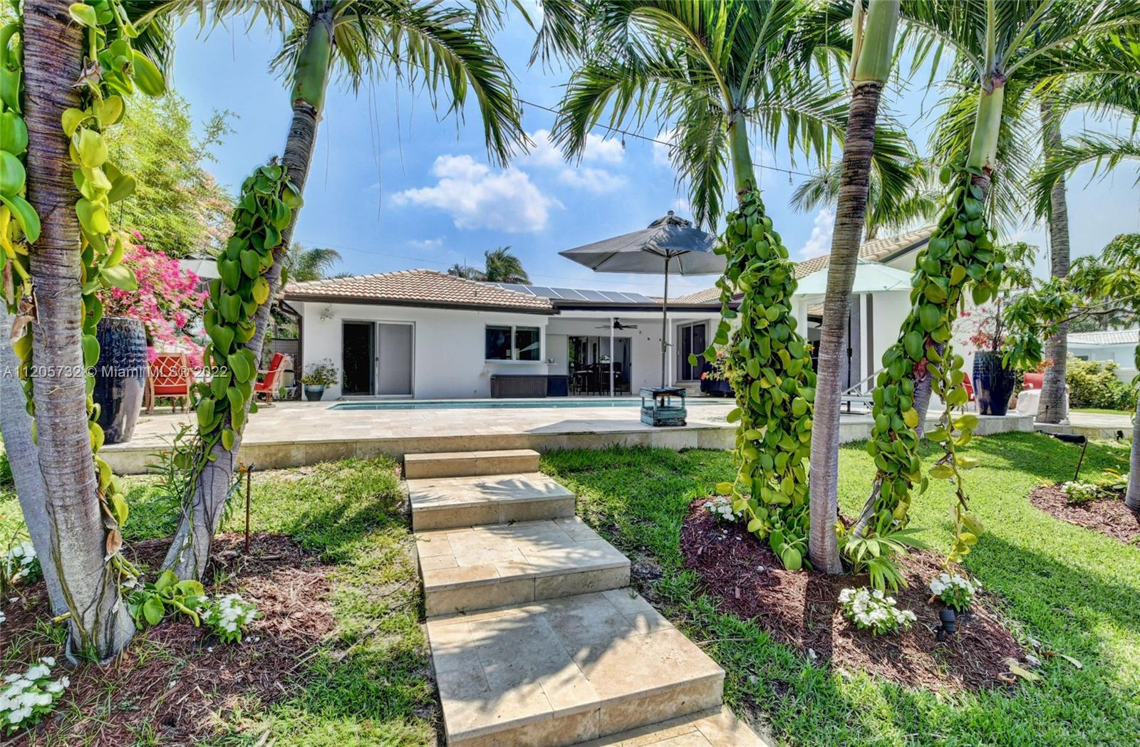 1291 Southwest 4th Court Boca Raton, FL 33432 - Photo 33 of 54 a front view of a house with garden