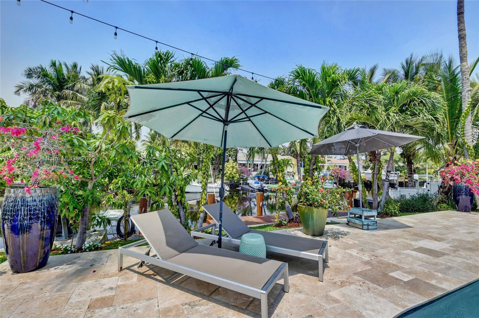 1291 Southwest 4th Court Boca Raton, FL 33432 - Photo 34 of 54 a view of a chair and table with umbrella in the garden