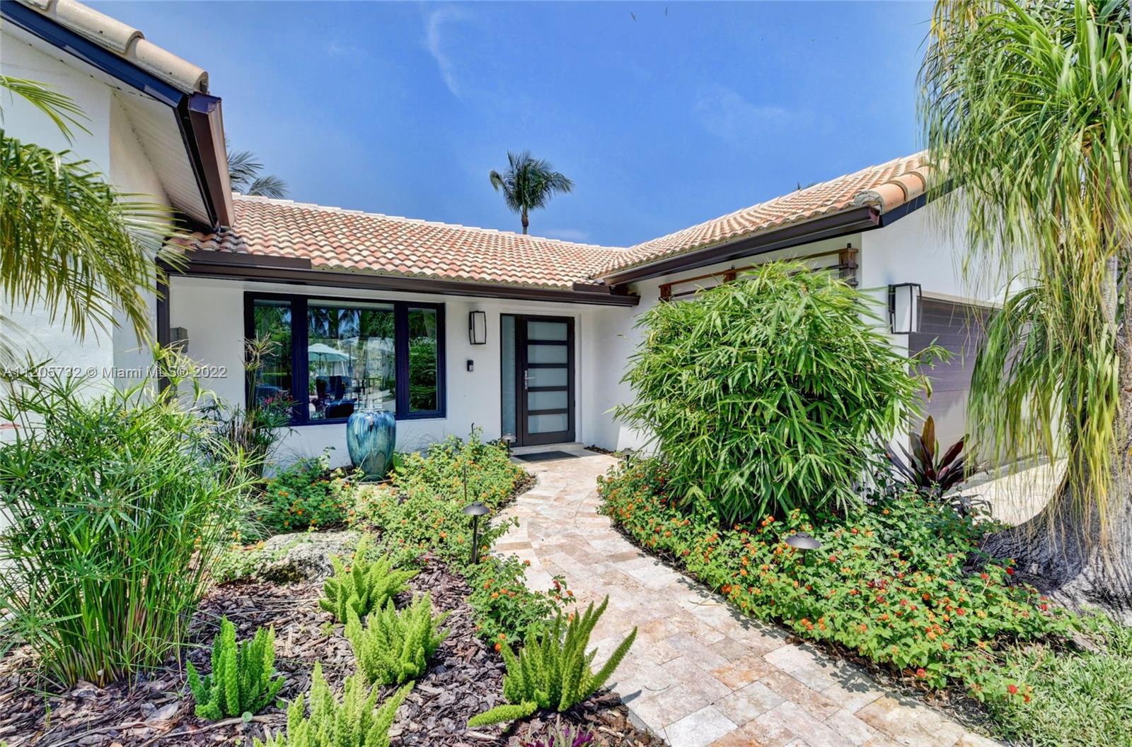 1291 Southwest 4th Court Boca Raton, FL 33432 - Photo 4 of 54 a view of a porch with a potted plant and floor to ceiling windows