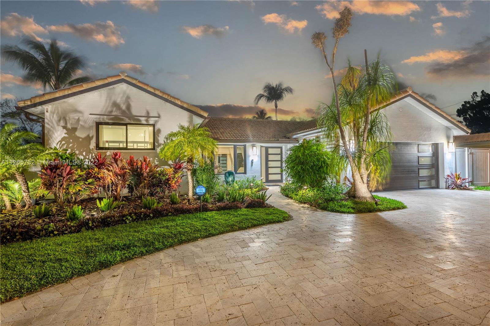 1291 Southwest 4th Court Boca Raton, FL 33432 - Photo 44 of 54 a front view of a house with a yard and potted plants