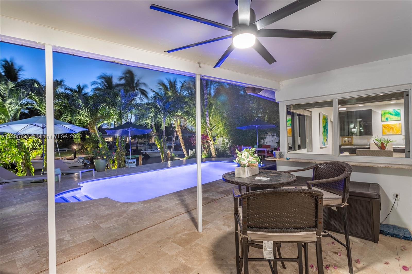 1291 Southwest 4th Court Boca Raton, FL 33432 - Photo 53 of 54 a view of a patio with dining table and chairs under an umbrella
