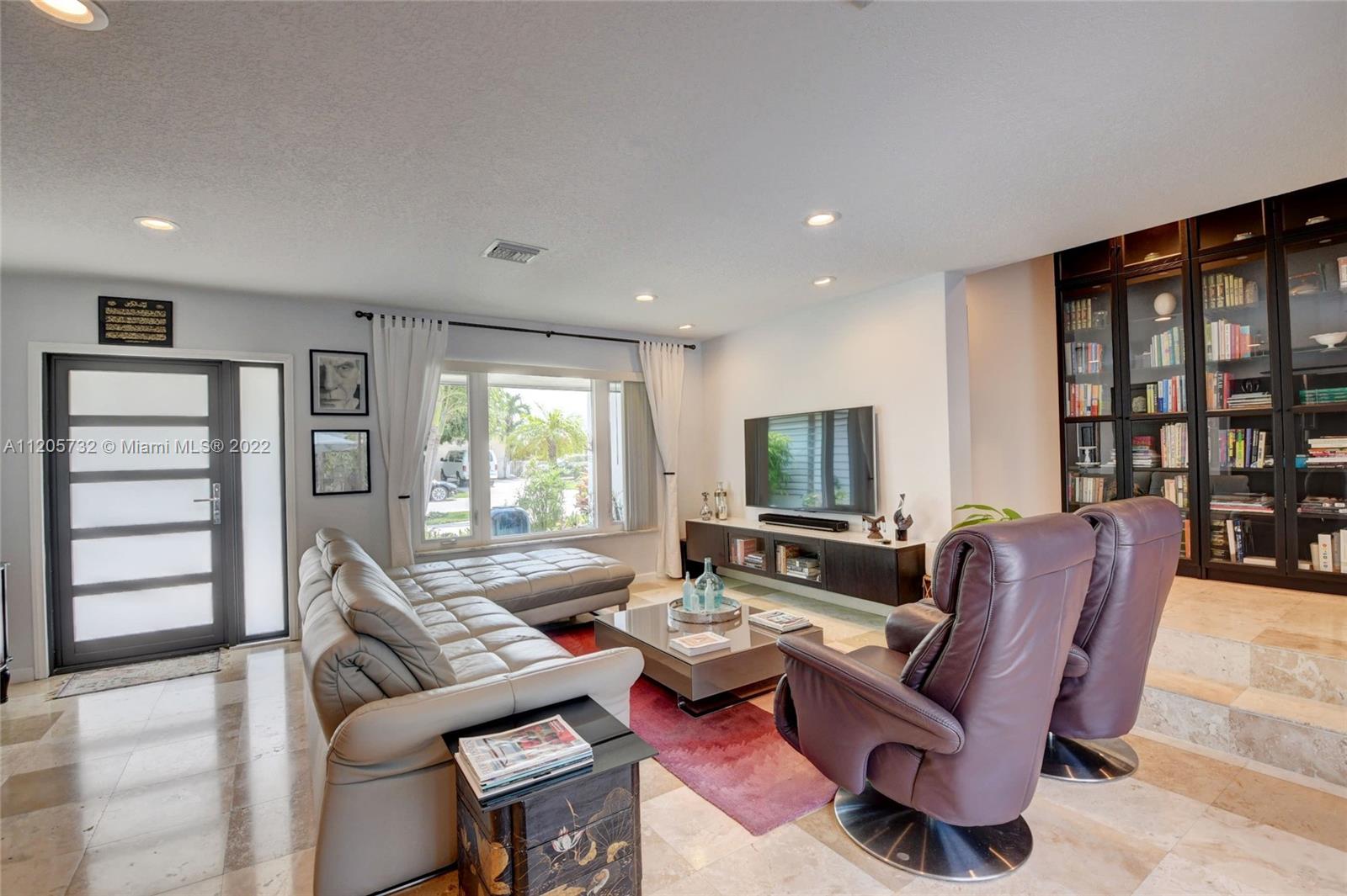 1291 Southwest 4th Court Boca Raton, FL 33432 - Photo 7 of 54 a living room with furniture and a flat screen tv