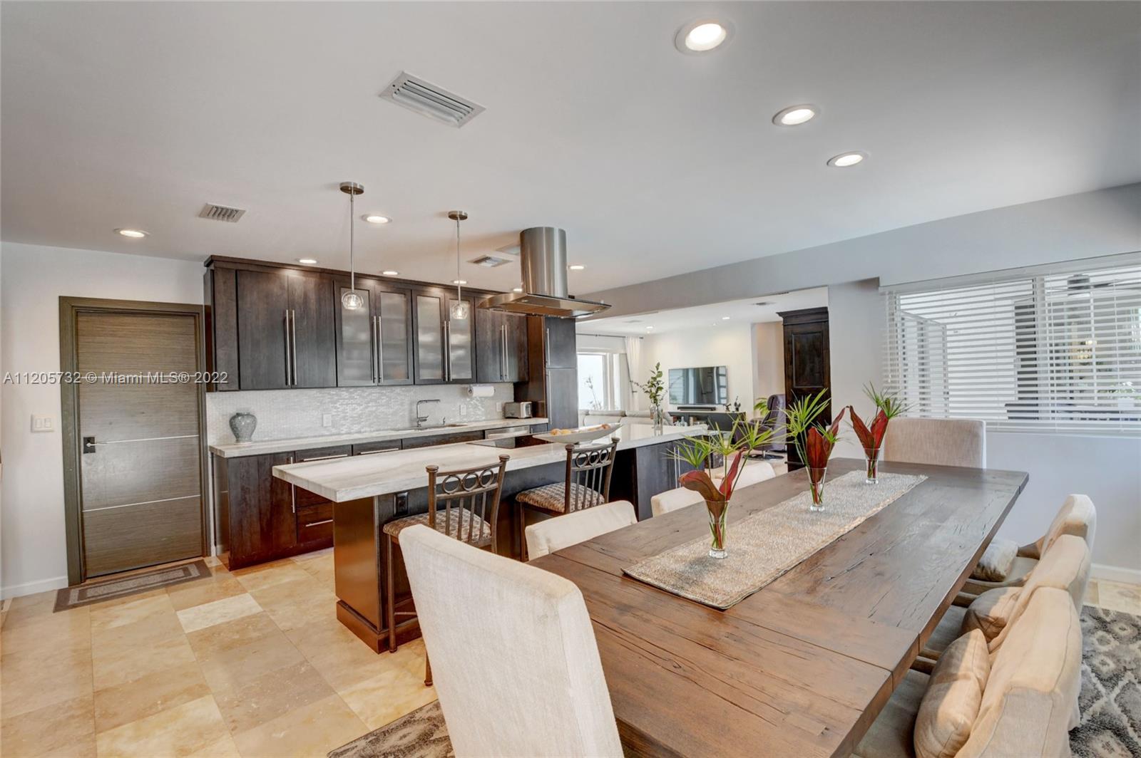 1291 Southwest 4th Court Boca Raton, FL 33432 - Photo 9 of 54 a living room with stainless steel appliances furniture a rug and a kitchen view