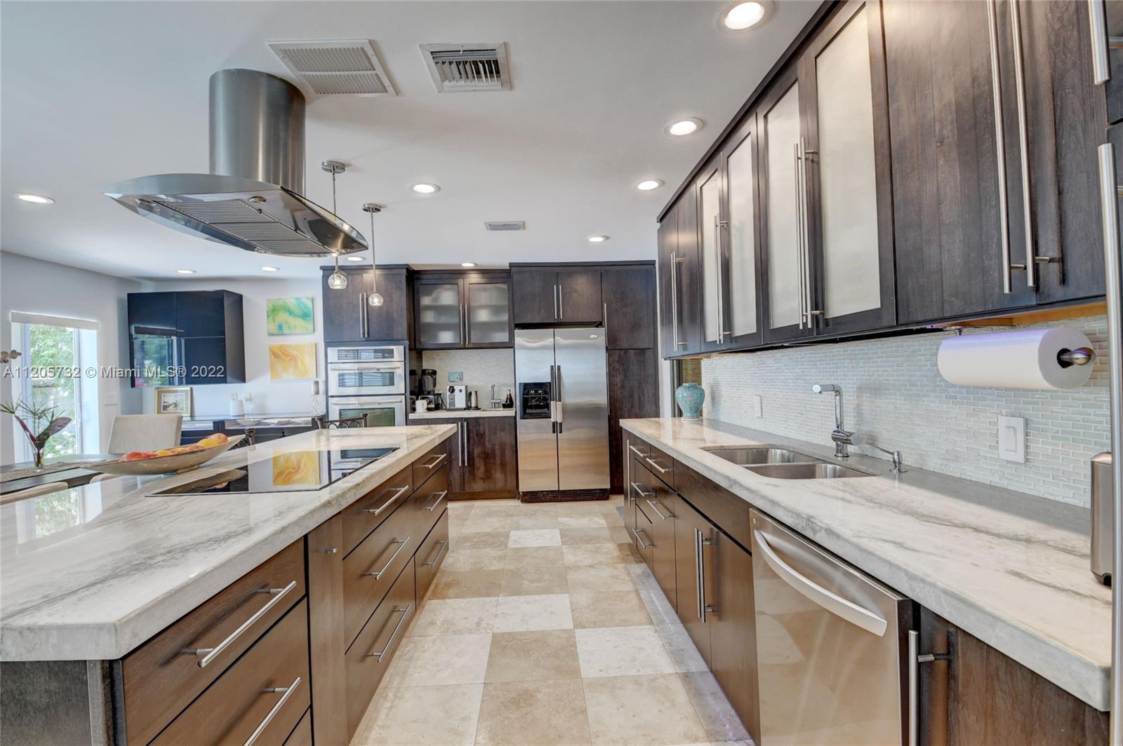 1291 Southwest 4th Court Boca Raton, FL 33432 - Photo 10 of 54 a large kitchen with stainless steel appliances lots of counter space and a sink