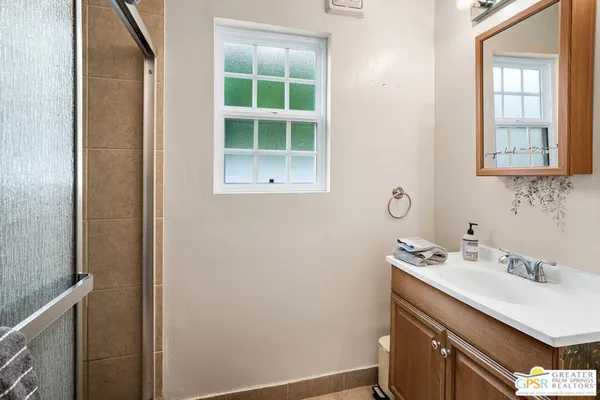 a bathroom with a sink vanity and a mirror