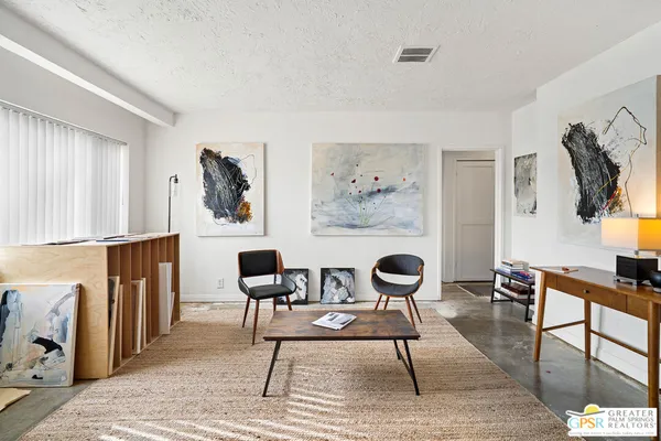 a living room with furniture a rug and a window