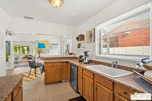 a kitchen with stainless steel appliances granite countertop sink stove top oven and cabinets