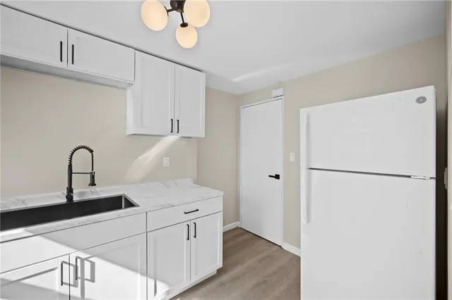 a kitchen with a refrigerator and a sink