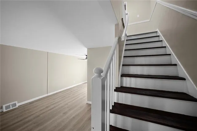 a view of entryway with wooden floor and stairs