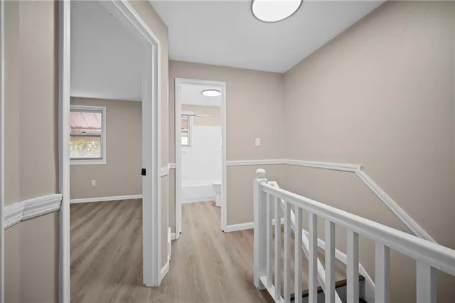 a view of hallway with wooden floor
