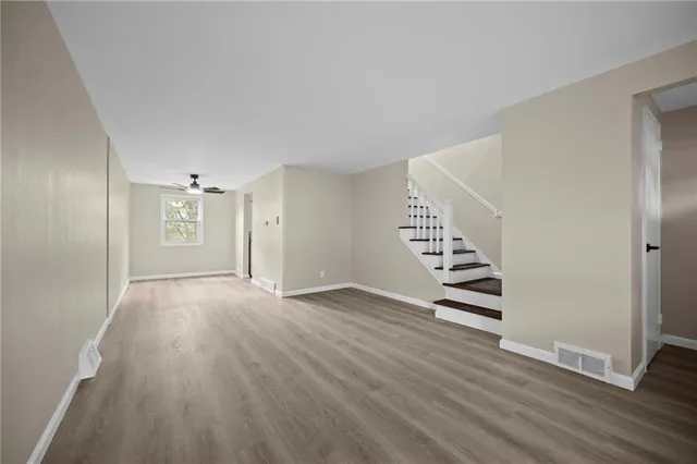 wooden floor in an empty room with a window