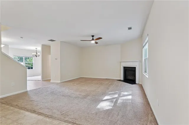 a view of an empty room with a fireplace
