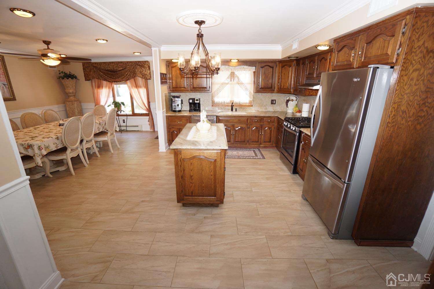 77 Inwood Avenue Colonia, NJ 07067 - Photo 11 of 37 a kitchen with stainless steel appliances granite countertop a refrigerator a stove top oven a sink dishwasher and a refrigerator