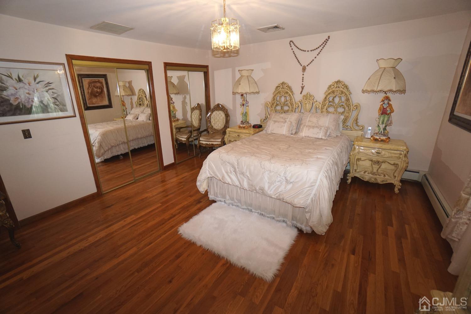 77 Inwood Avenue Colonia, NJ 07067 - Photo 15 of 37 a bedroom with a bed and wooden floor