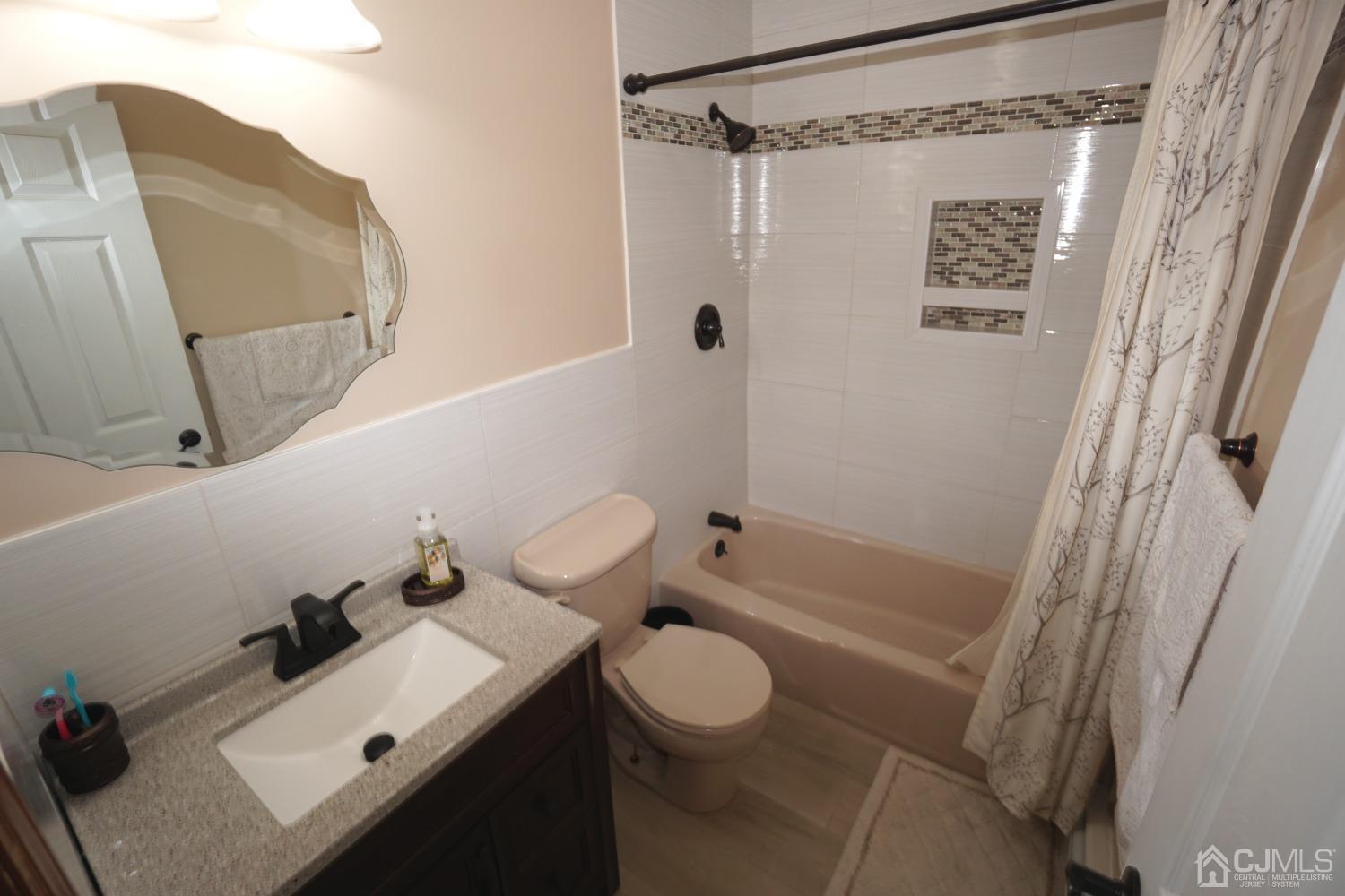 77 Inwood Avenue Colonia, NJ 07067 - Photo 20 of 37 a bathroom with a sink toilet and shower