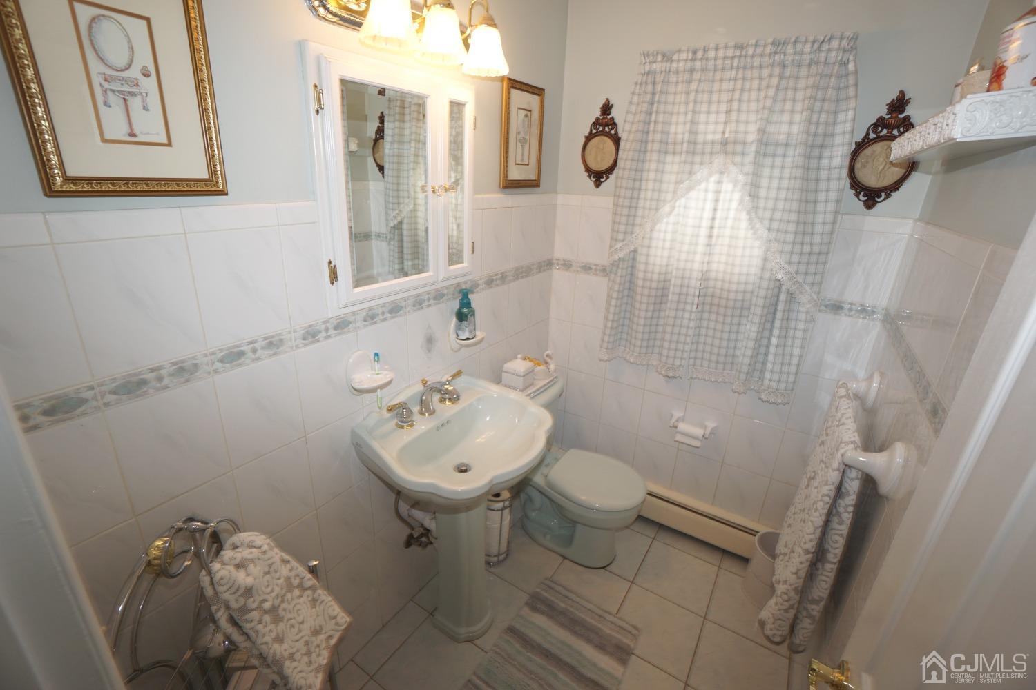 77 Inwood Avenue Colonia, NJ 07067 - Photo 21 of 37 a bathroom with a sink toilet and shower