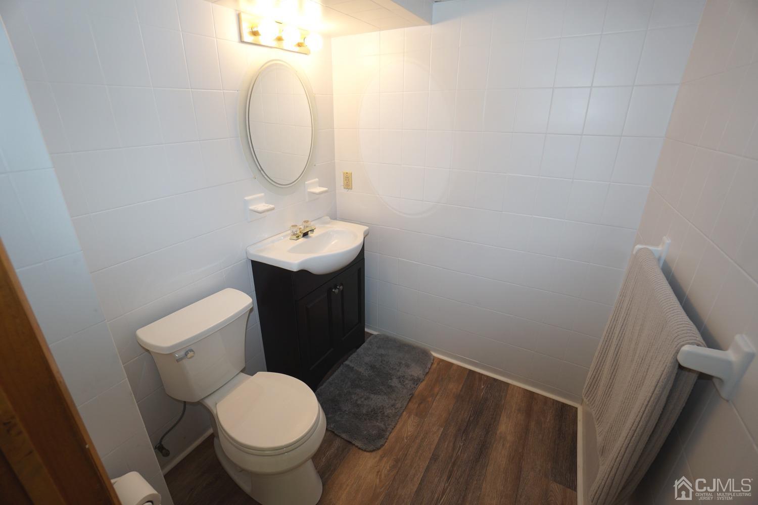 77 Inwood Avenue Colonia, NJ 07067 - Photo 25 of 37 a bathroom with a toilet sink and mirror