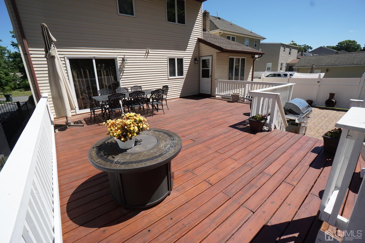 77 Inwood Avenue Colonia, NJ 07067 - Photo 30 of 37 a view of a patio with table and chairs potted plants with wooden floor