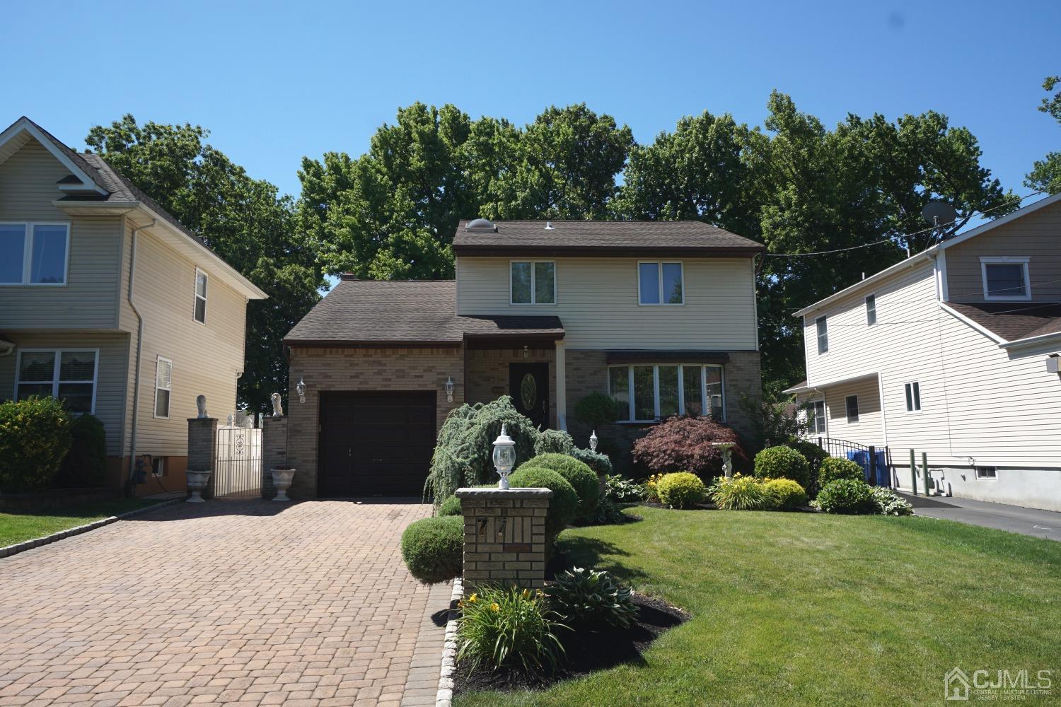77 Inwood Avenue Colonia, NJ 07067 - Photo 3 of 37 a front view of a house with garden